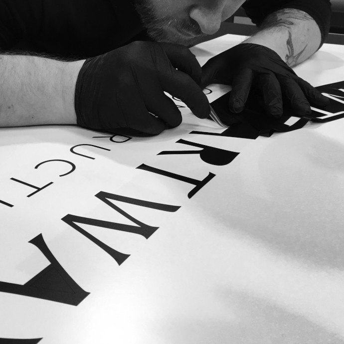 Man at work creating custom printed graphic for the Chartway group