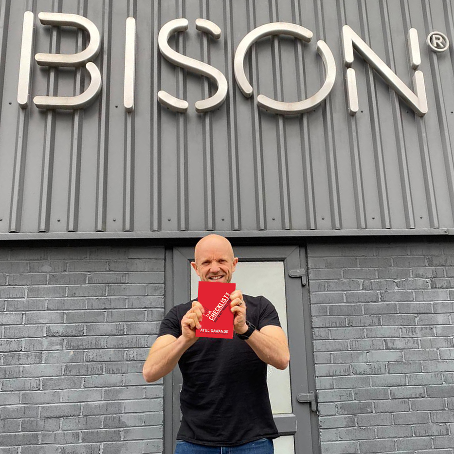 Managing Director Mark Bidwell Standing In Front Of The Bison Headquarters Holding A Copy Of The Book The Checklist